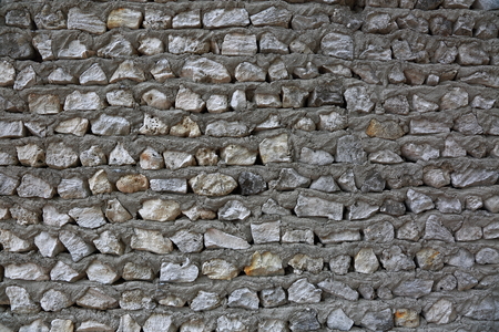 Texture of gray stone wall. Gray stone wall and cement solution as background or texture.の写真素材