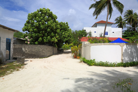 View of the village of Maldive Islands. Green trees and old buildings. Local society.の写真素材