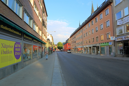 View of street of Uppsala, Sweden, Europe. Red buildings on blue sky background. 07.28.2018.のeditorial素材