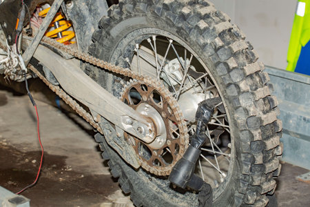 Close up view of a dirty motorbike wheel isolated. Transport background. Car repair shop. Service. Garage.の写真素材