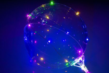 Beautiful balloon with colorful lights on blue background. Party / holidays background.の写真素材