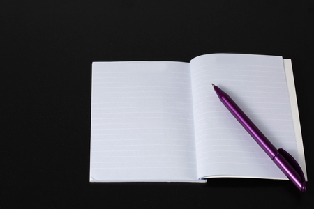 Notepad and pen on black background. Business / Finance / School concept. Business / Finance / School backgrounds.の写真素材