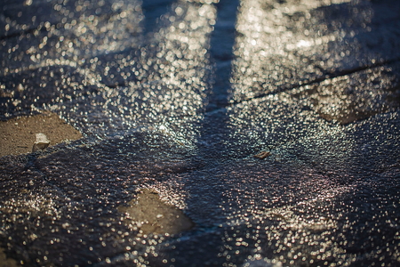 Beautiful background. Close up view of icy sidewalk on sunshine day.の写真素材
