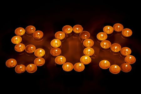 Close up view of SOS sign of tealights. Beautiful backgrounds.の写真素材