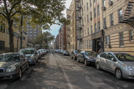 Brighton beach neighborhood. Yellow buildnings and parked cars. Beautiful landscape backgrounds. 09.26.2012 USA. New York.のeditorial素材