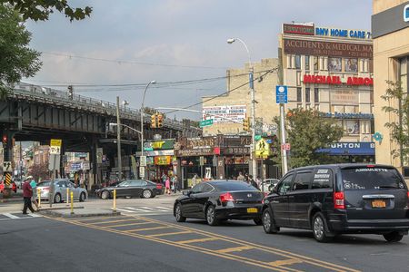 Beautiful street of Brighton Beach neighborhood. Car traffic and people concept. 09.27.2012. New York. USA.のeditorial素材