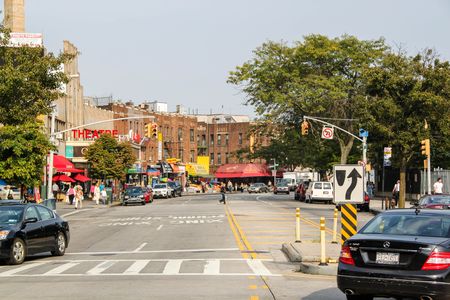 Beautiful street of Brighton Beach neighborhood. Car traffic and people concept. 09.27.2012. New York. USA.のeditorial素材