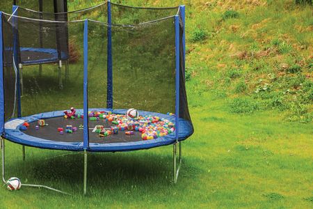 A line of trampolines with safety net mounted on backyards. Activity concept.の写真素材
