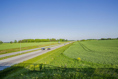 Several cars. Bright green day Beautiful nature background.の写真素材