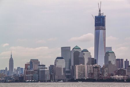 Gorgeous view of Manhattan skyline. High buildings on blue sky with white clouds background. Beautiful backgrounds. New York. USAの写真素材
