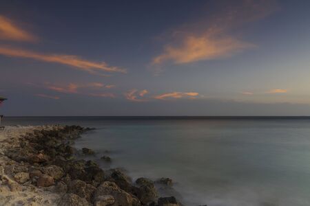 Gorgeous colorful view of sunset on Aruba. Beautiful nature landscape. Rocky coast of Atlanta, Caribbean.の写真素材