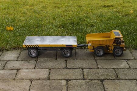 View of radio controlled model dump truck and trailer Free time. Children and adults concept. Hobby. Toys.の写真素材