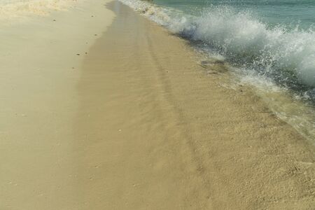 Big wave in Caribbean sea is breaking the coast. Eagle Beach of Aruba Island. Beautiful nature background.の写真素材