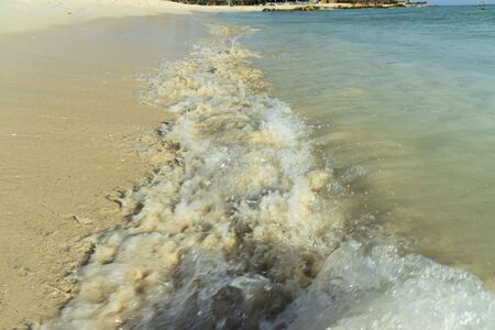 Big wave in Caribbean sea is breaking the coast. Eagle Beach of Aruba Island. Beautiful nature background.の写真素材
