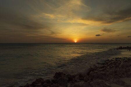 Gorgeous colorful view of sunset on Aruba. Beautiful nature landscape. Rocky coast of Atlanta, Caribbean.の写真素材
