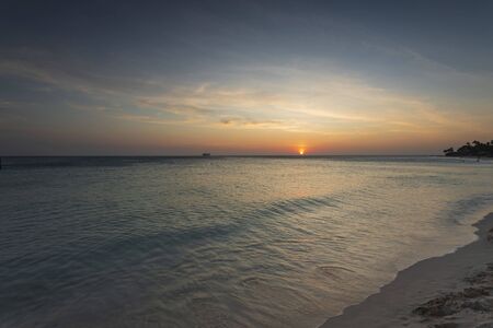 Amazing sunset on Eagle Beach of Aruba Island. Caribbean.Unforgettable view. Beautiful nature background.の写真素材