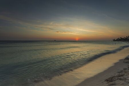 Amazing sunset on Eagle Beach of Aruba Island. Caribbean.Unforgettable view. Beautiful nature background.の写真素材