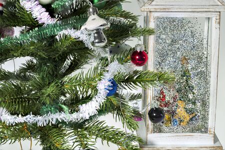 Close up view of decorative Christmas tree with small toys and decorative figure of Santa Claus. Christmas Holiday Concept. Postcard. Beautiful backgrounds.の写真素材