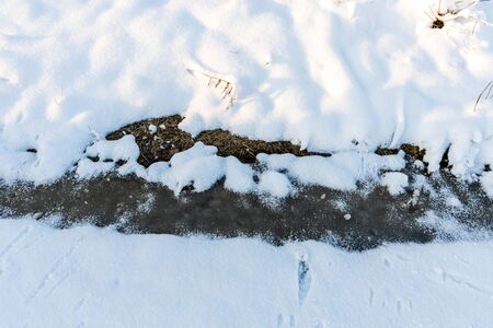 Beautiful view background of snow in winter. Stream in winter forest. Gorgeous winter background.の写真素材