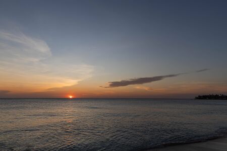 Amazing sunset on Eagle Beach of Aruba Island. Unforgettable view. Beautiful nature landscape.の写真素材