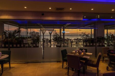 Gorgeous view of restaurant interior with ocean landscape on background. Oranjestad. Aruba. 17.17.2019.のeditorial素材