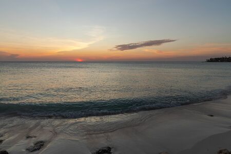 Amazing sunset on Eagle Beach of Aruba Island. Unforgettable view. Beautiful nature landscape.の写真素材