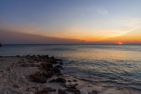 Amazing sunset on Eagle Beach of Aruba Island. Unforgettable view. Beautiful nature landscape.の写真素材
