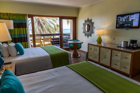 Interior view of hotel room. Big beds, table with armchair and balcony. Tourism concept. Willemstad. Curacao.のeditorial素材