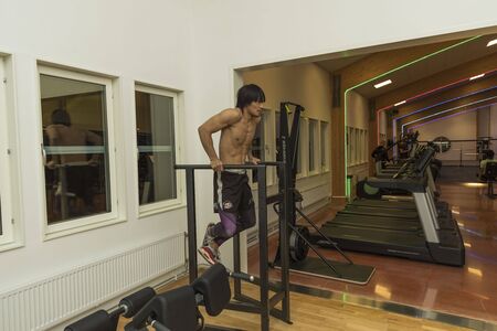 Close up view of young male training in gym. Sport and healthy lifestyle concept. Enkoping. Sweden 07/11/2019のeditorial素材