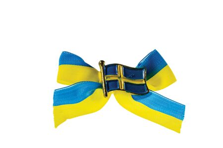 Close up macro view of metal badge in form of swedish flag on blue yellow bow.の写真素材