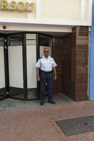 Police officer outside of police station isolated. Profession concept. Willemstad. Curacao. 09/09/2019.のeditorial素材
