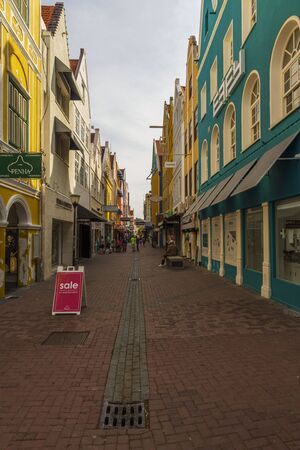 Beautiful town landscape view. City residents and tourists on street with beautiful architecture on hot summer day. Willemstad. Curacao. 09/09/2019.のeditorial素材