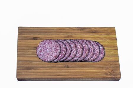 Close up view of salami sausage slices on wooden background. Food concept.の写真素材