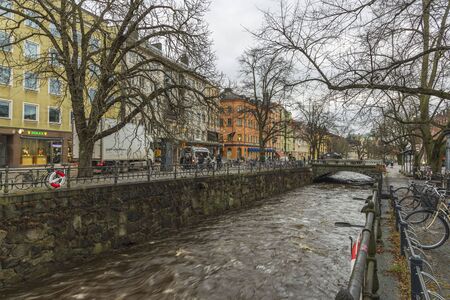 Gorgeous view on street near river on background. Gorgeous sky with thunderclouds on a winter day. Tourism, travel concept. Europe, Sweden, Uppsala. 12.30.2019.のeditorial素材
