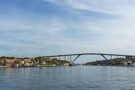 Beautiful view of famous Queen Juliana Bridge. Gorgeous ocean landscape on blue sky background. Willemstad. Curacao.の写真素材
