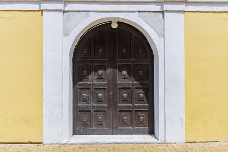 Close up view of big antique brown front entrance door as element of building.の写真素材
