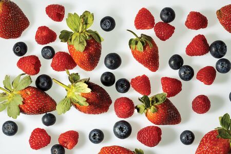 Close up view of colorful berries on white background. Healthy food concept.の写真素材