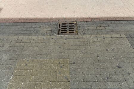 Close up view of outdoor sewer grate for water drainage isolated.の写真素材