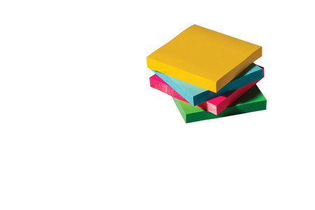 Close up view of colorful post notes blocks isolated on white background.