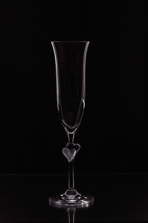 Close up view of contour of a beautiful glass with fine edges isolated on a black background. Beautiful background.の写真素材