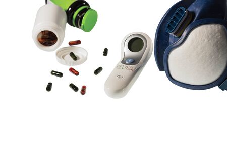Close up view of colorful pills, thermometer and respirator face mask isolated on white background. Health concept.の写真素材