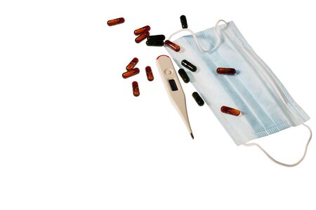 Close up view of face mask, colorful pills and white thermometer isolated on white background. Health concept.の写真素材