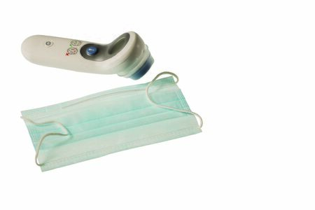 Close up view of face mask and kind of thermometer isolated on white background. Health concept.の写真素材