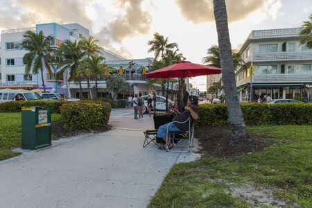 Beautiful landscape view of street in Miami South Beach. Souvenir shop and tourists on beautiful buildings and cloudy sky background. Miami USA 24/09/2019.のeditorial素材
