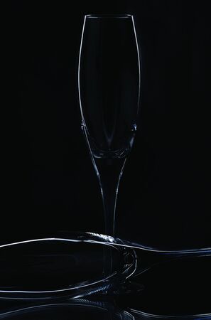Close up view of contour of a beautiful two slim, tall and elegant champagne glasses isolated on a black background. Beautiful background.の写真素材