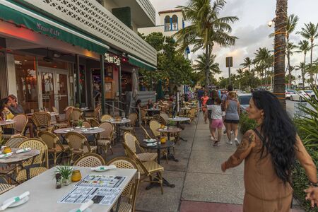 Close up view of outdoor cafe with clients at some of tables. Tourism concept. USA Miami South Beach. 24/09/2019.のeditorial素材