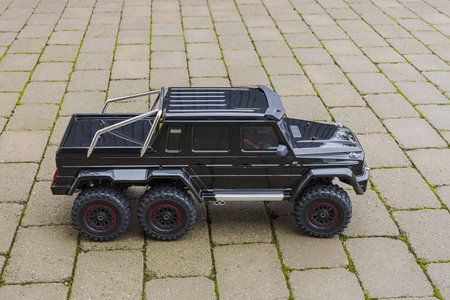 View of radio controlled model racing car on off-road background. Toys with remote control. Free...