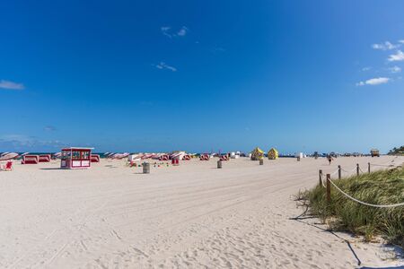 Beautiful landscape view of Miami South Beach coast line. Sand beach, Atlantic Ocean, people and high buildings on blue sky and white clouds background. USA Miami Beach.のeditorial素材