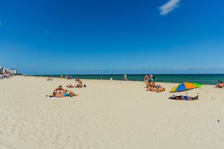 Beautiful landscape view of Miami South Beach coast line. Sand beach, Atlantic Ocean, people on blue sky background. USA Miami Beach. 24/09/2019.のeditorial素材