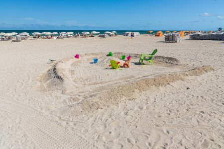 Beautiful landscape view of Miami South Beach coast line. Atlantic Ocean, Cute view of colorful sand toys on sandy beach. Family tourism concept.の写真素材